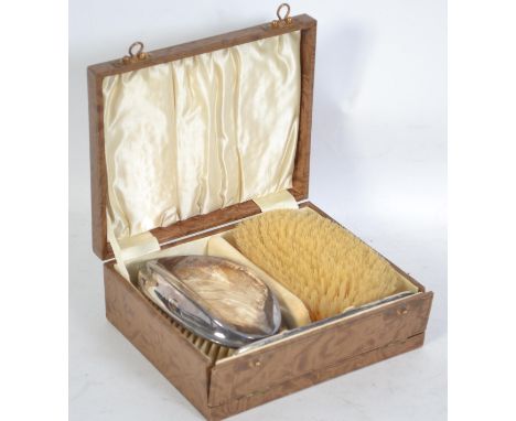 A silver hallmarked pair of clothes brushes and comb complete in the original box. The silver hallmarked for BIrmingham 1928 