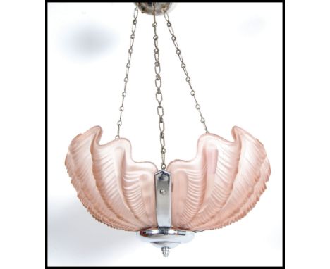 An Art Deco peach molded glass shell with ceiling light. &nbsp;An interesting piece with detailed scalloped edges.