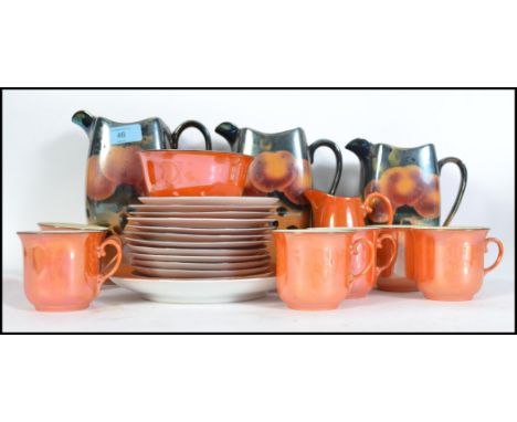 A vintage 20th century graduating set of three lustre jugs together with a lustre six person tea service.