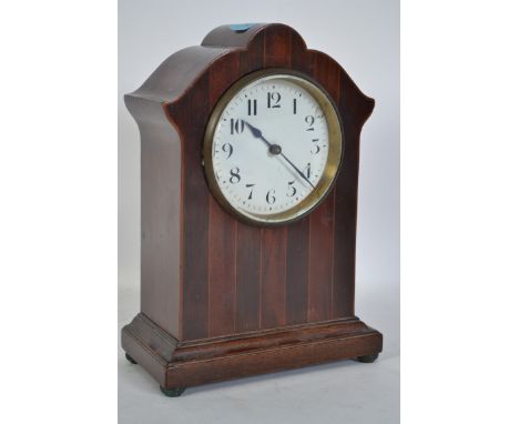 An Edwardian mahogany mantle clock having a cylindrical French brass movement