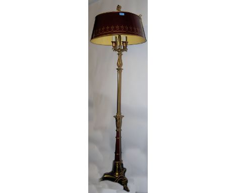 A &nbsp;good 20th century brass standard coaching lamp raised on a tripod base with brass paw feet. The brass base with red l