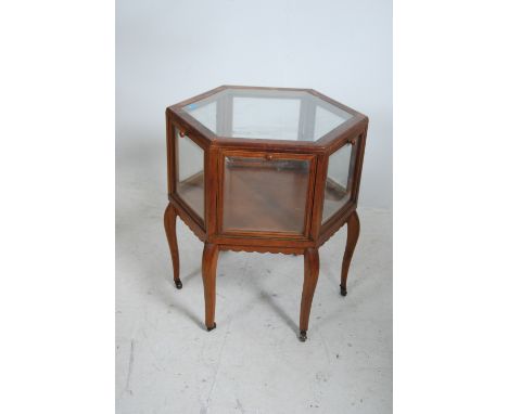 An early 20th century mahogany bijouterie drum table display cabinet. The table being raised on shaped legs with brown cerami