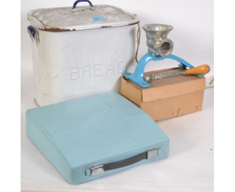 A vintage mid 20th century white enamel bread bin together with a Spong mincer and a cased Imperial typewriter.