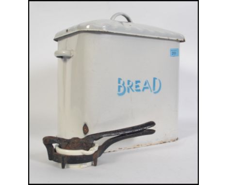 A vintage mid 20th century enamel bread bin of rectangular form having a &nbsp;scalloped sarcophagus lid with handle atop. Wh