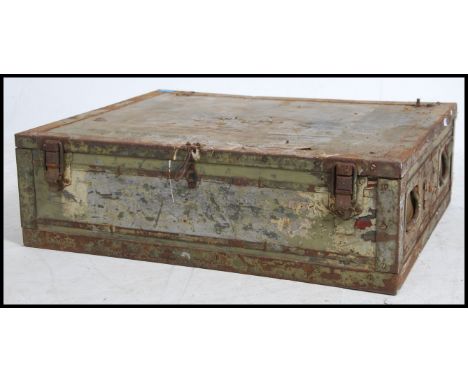 A vintage 20th century tin steamer trunk of square form, hinged lid and clasps to the front.
