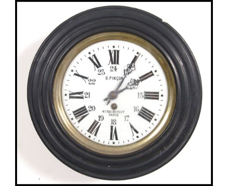 A French ebonised early 20th century bulls eye wooden cased pendulum station clock with a hinged and framed spherical glass f