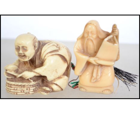 A bone Netsuke of an elder together with another, signed to base. One leaning over a basket, the other with scroll. Measures 