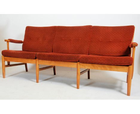 A 20th century contemporary Farstrup Danish 3seat sofa settee being raised on light wood turned supports with show wood frame