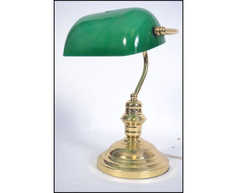 A 20th century bankers desk / work lamp having brass base and upright support below the green glass shade. Measures: 36cms hi