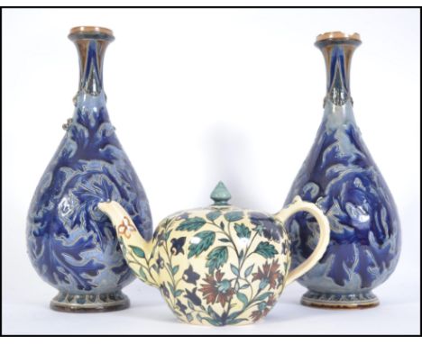 A 19th century Faience&nbsp;ceramic ware teapot decorated with foliate design together with a pair of Doulton Lambeth vases s