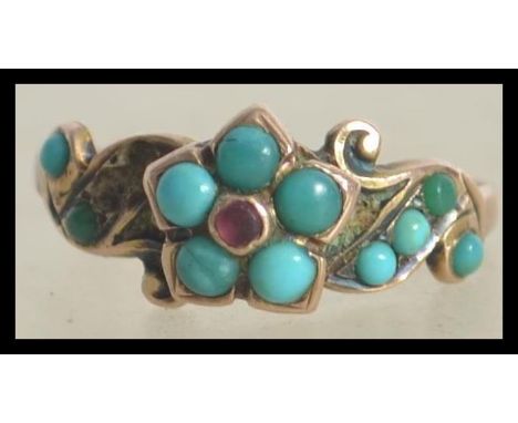 A believed Victorian 9ct / 375 hallmarked ladies turquoise and ruby ring. Set on a gypsy setting with central small ruby with