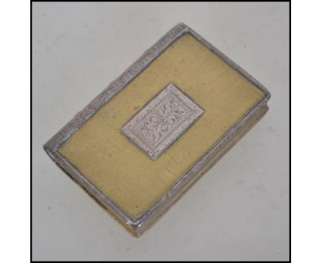 A 19th century silver and gilt metal pill box / snuff tin in the form of a book. The silver spine and cartouche with gilt met