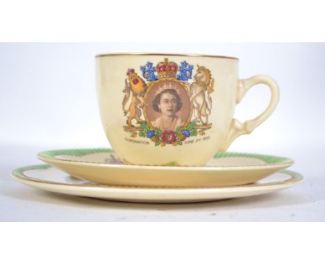 A Clarice Cliff ceramic trio for the Coronation of the Queen 1953 having pictorial crest with green glazed borders. Stamped t