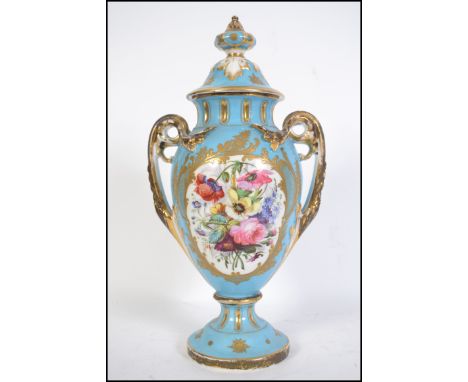 A Victorian ceramic twin handles vase - amphora in the manner of Meissen. The vase with blue ground having white cartouche's 