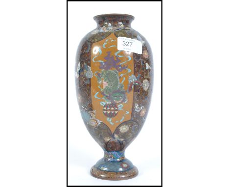                         A Chinese baluster vase, decorated with enamel dragon panels on dark ground with incised decoration. 