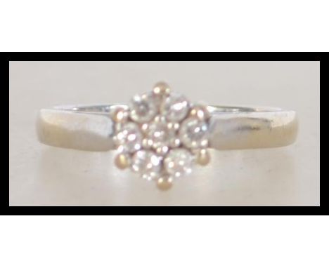A hallmarked 18ct white gold diamond cluster ring with a 25pts diamonds in a high prong cluster setting. Hallmarked for Sheff