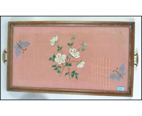 A vintage early 20th century butlers tray inset with glass tapestry needlepoint. The tray with brass handles