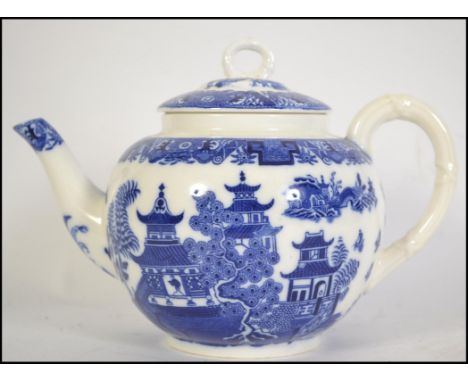 A Royal Worcester blue and white porcelain teapot in the ' Willow ' pattern having green backstamp with 7 dots and star date 