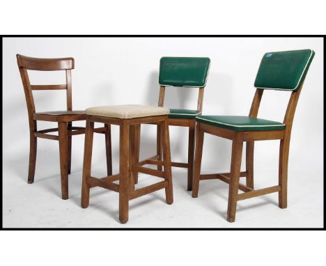 A pair of vintage mid 20th century green vinyl dining chairs with white piping detail, together&nbsp;with a vintage stool and