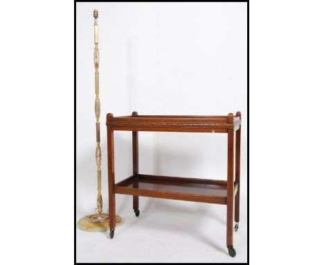 A vintage mid 20th century oak drinks / hostess two tiered trolley together with an Onyx standard lamp. Measures 74cm high x 