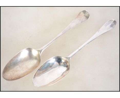 A near pair of George 2nd 18th century silver hallmarked tablespoons. One believed to be by R &amp; S Garrard &amp; Co - Robe