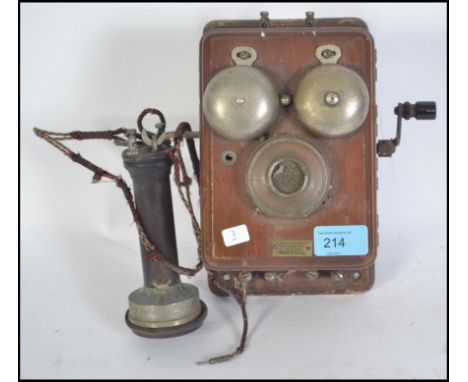 A vintage early 20th century Efesco wall mounted stick telephone with plaque inscribed Efesco with original wire and handle w