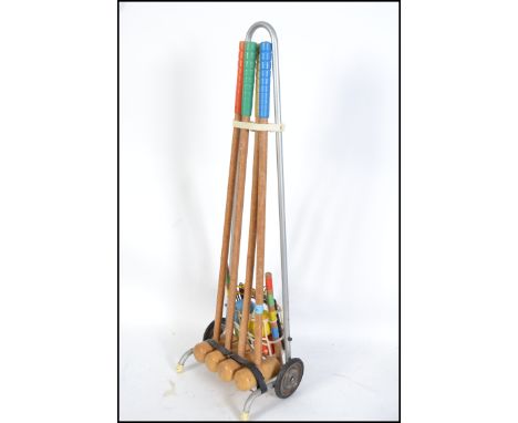 A vintage mid 20th century retro garden croquet set complete with hammers,ball, hoops etc all on trolley