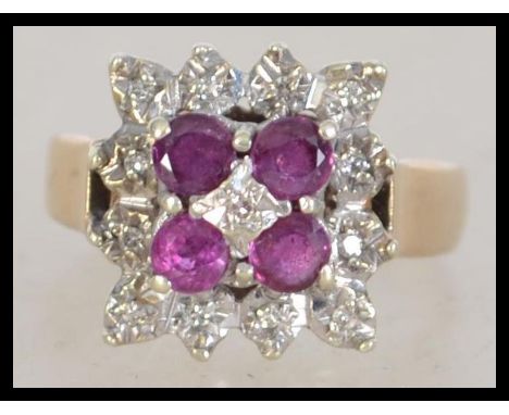 A vintage ladies 9ct gold and ruby diamond ring of cluster form having 4 round cut rubies to illusion setting. Size P / Weigh