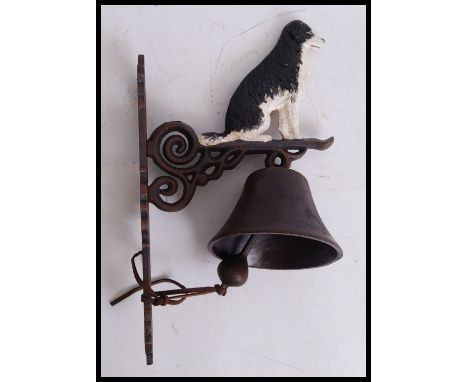 A vintage style, 20th century cast iron border collie bell. Measures 34cms tall.&nbsp;