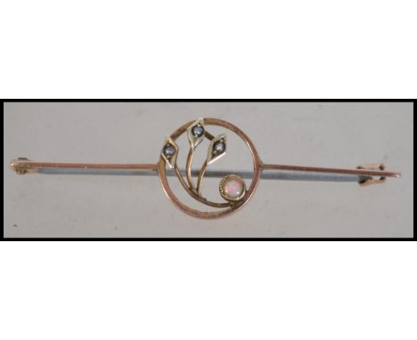 An Art Nouveau 9ct gold opal and pearl brooch having a c clasp. Marked 9ct tests 9ct gold. Measures 5 cms. Weight 2g.