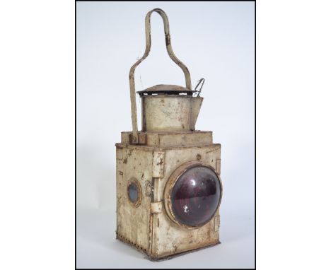 A vintage mid 20th century guardsman railway lamp with red convex glass, carry handle atop painted white. Measures 50cm high.