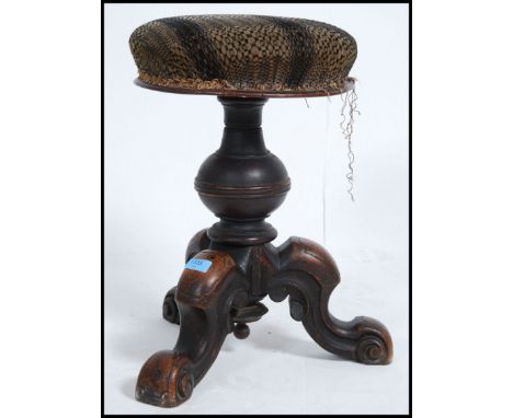 A Victorian revolving walnut piano stool, with over stuffed seat pad. Measures 50cm high x 42cm wide x 42cm deep.