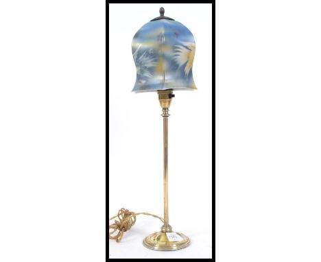 A vintage 20th century brass table lamp. The brass column being supported by a circular base with a stunning Art Deco milk gl