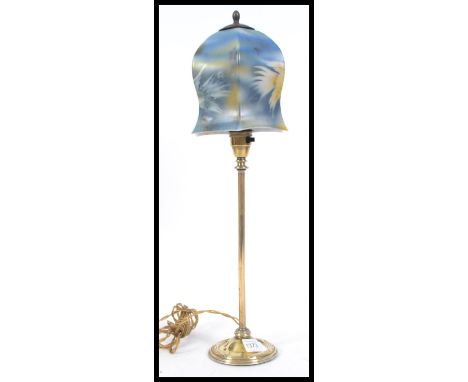 A vintage 20th century brass table lamp. The brass column being supported by a circular base with a stunning Art Deco milk gl