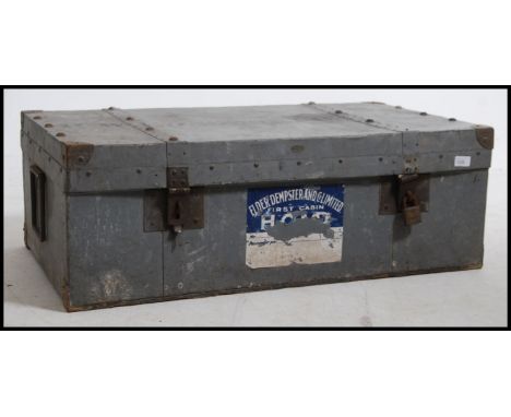 A substantial vintage early 20th century metal steamer trunk. Large carry handles to the side with metal stud corner detailin
