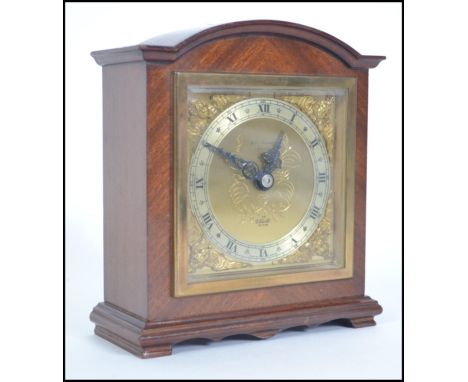 A good quality 20th century mahogany cased mantel clock by Elliott having retailers notation to centre for John Bennett of Br