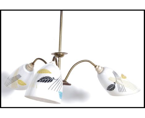 A vintage mid 20th century three branch ceiling light fixture having conical glass light shades together with a pair of match