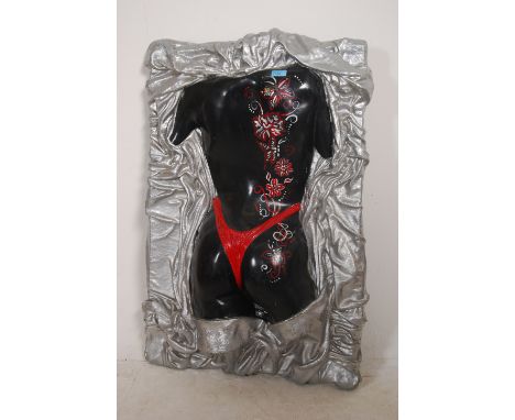An unusual 20th century resin cast wall mount sculpture of a lady in bikini having handpainted finish and silver surround