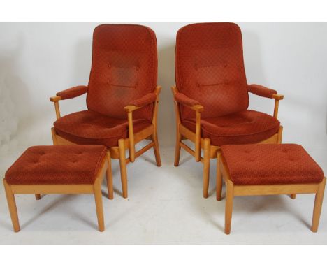 A 20th century contemporary Farstrup Danish pair of armchairs raised on light wood turned supports with show wood frames havi