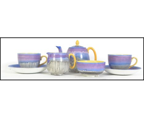 A 1930's Art Deco Shelley China tea service for 2 having drip glaze decoration with yellow handles. The set comprising teapot