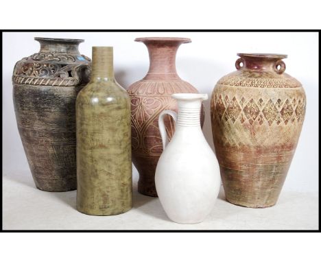 A collection of large floor standing highly decorated amphora's together with a large ceramic / stoneware ewer.