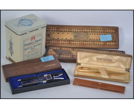 A good mixed lot to include 2 Sheaffer cased pen sets, a polished blue stone bottle stopper, 2 vintage Cribbage boards from t