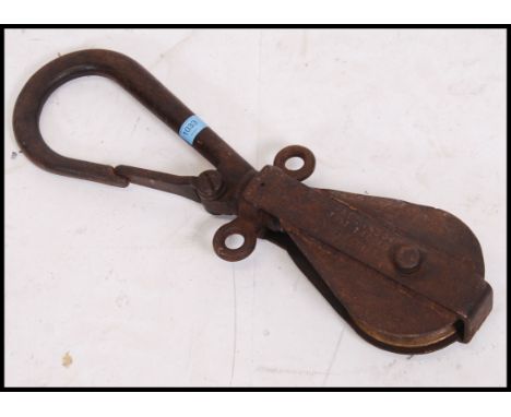 A vintage mid 20th &nbsp;century &nbsp;Industrial heavy cast metal industrial pulley with hook inscribed HV4122 1962 Pat 1435