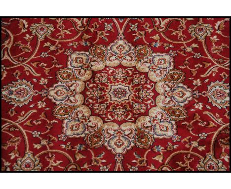 A large North Western Iranian / Persian Heriz carpet - rug having red and beige ground with geometric decoration and borders.