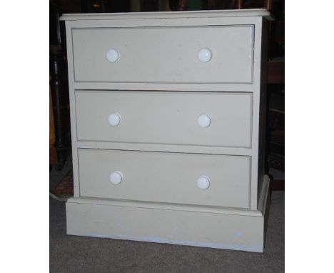 An antique style dwarf painted pine chest of drawers having plinth base and flared top with white ceramic handles to the draw