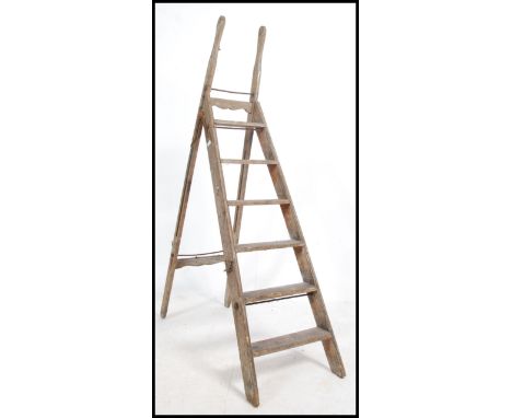 A good 19th century Industrial step ladder with shaped cast iron bracket work to the extending a-frame steps. Measures: 190cm