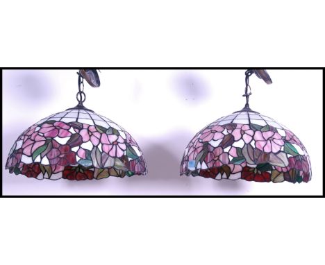 A pair of vintage 20th century Tiffany style leaded glass hanging ceiling light shades with sectioned floral design. Measures