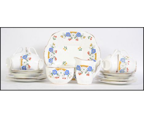 A 1930's Art Deco Staffordshire tea service in a good chintz pattern comprising cups, saucers, plates, sugar bowl and crea,er