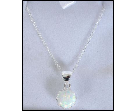 A contemporary ladies silver and opal pendant necklace being set on a silver chain complte in the presentation case. Measures