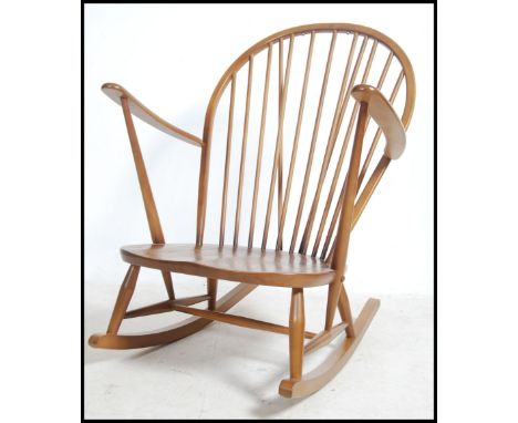 A 20th century Golden Dawn Ercol beech and elm Quaker spindle back rocking chair
